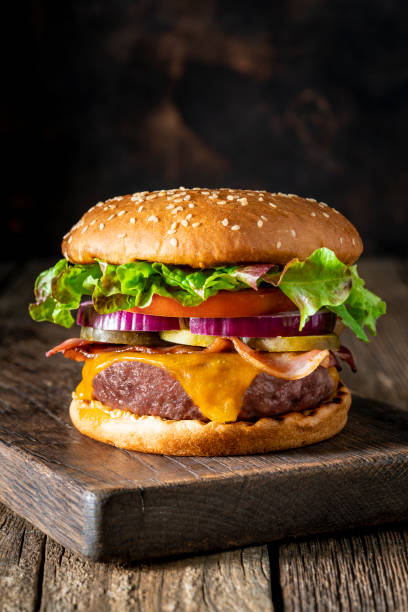 istock Cheeseburger Burger Patty classic on rustic board of wood 1325880519