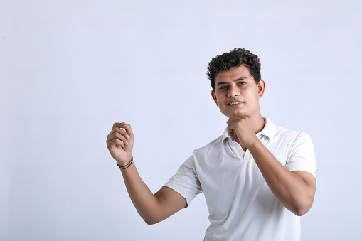 Young indian college student showing expression on white background