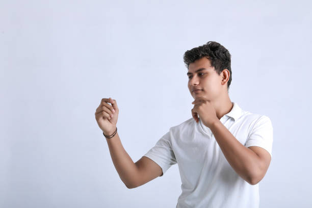 istock Young indian college student showing expression on white background 1325880867