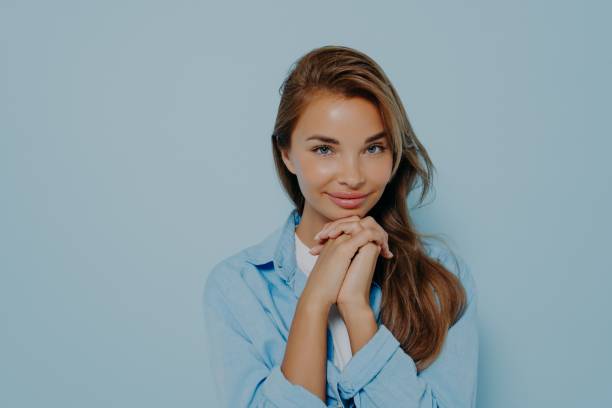 istock Confident woman with intrigued face expression on light blue background 1325882405