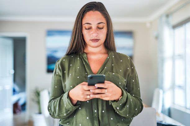 istock Shot of a young woman using her smartphone to send a text 1325883292