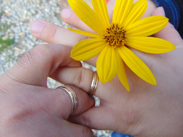 a couple holding hands and flower