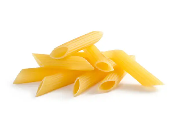 A small heap of Italian pasta Penne Rigate isolated on white backgroundu