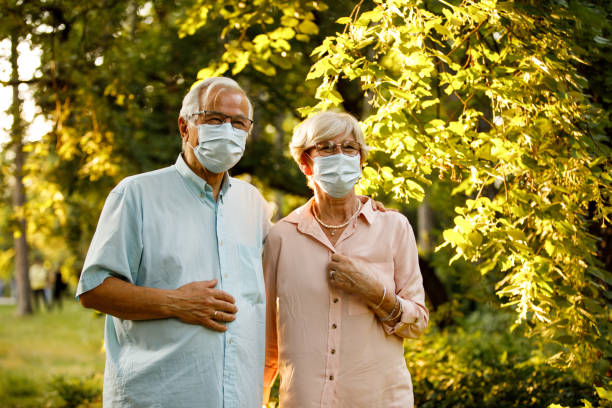 istock Cheerful mature couple going on a walk at the sunny park 1325887524