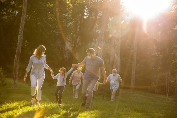 istock Three generation family taking a relaxing walk at the park 1325887525