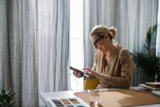istock Happy Businesswoman Using a Digital Tablet while Working from Home 1325887598