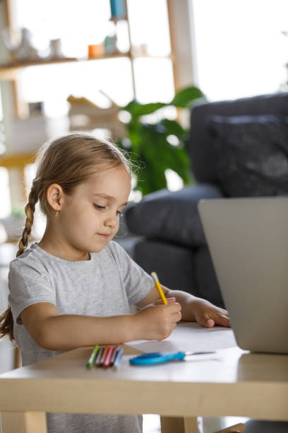 istock Cute little girl having fun drawing 1325888075