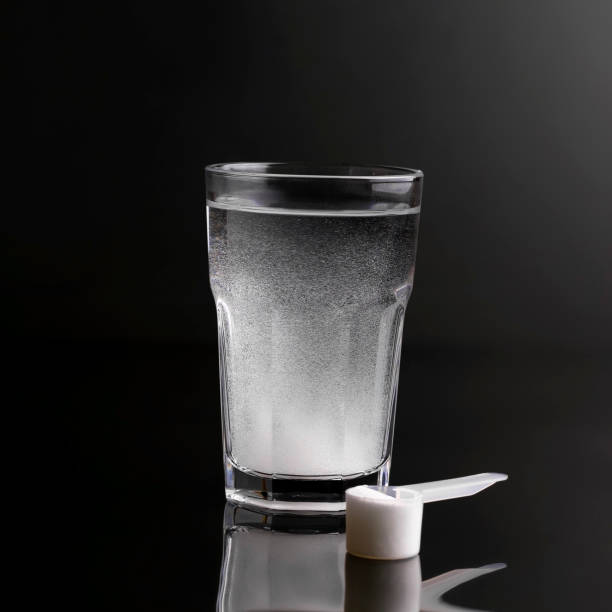 istock Drink for athletes in a glass on a black background 1325889058