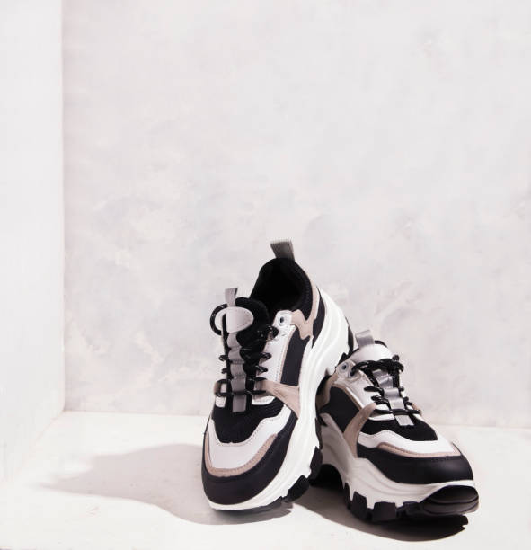 istock Sneakers with high soles on a gray background. Copy space. 1325889141