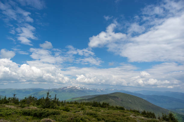 istock Mountain meadow, blue sky and clouds. View from the mountain 1325889578