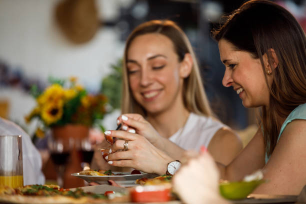 istock Woman putting ketchup on her pizza 1325890785