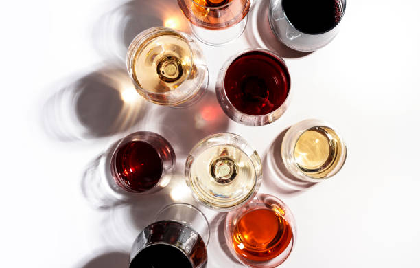 red, rose and white wine in glasses on white background, top view. wine bar, shop, winery, wine tasting concept. hard light and harsh shadows - wijn stockfoto's en -beelden