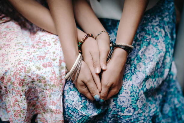 istock Hands of mom and daughter with boho bracelets. 1325894142