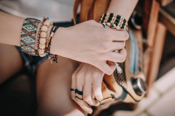 istock Female hands with boho accessories bracelets made of colored beads 1325894167