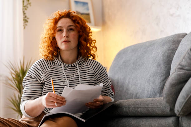 istock Serious female university student contemplating while studying for a test 1325894587