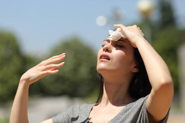 Asian woman drying sweat in a warm summer day Asian woman drying sweat in a warm summer day heat temperature stock pictures, royalty-free photos & images