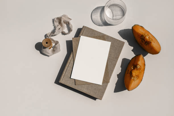istock Summer food still life composition. Cantaloupe melon fruit. Beige table background. Stationery mock up scene. Blank paper card, invitation. Glass of water, cocktail and old book in sunlight. Flat lay 1325895984