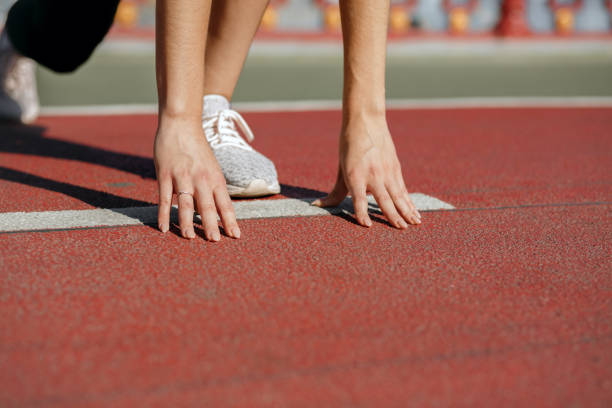 istock Woman athlete at starting position ready for the race. Empty space 1325896301