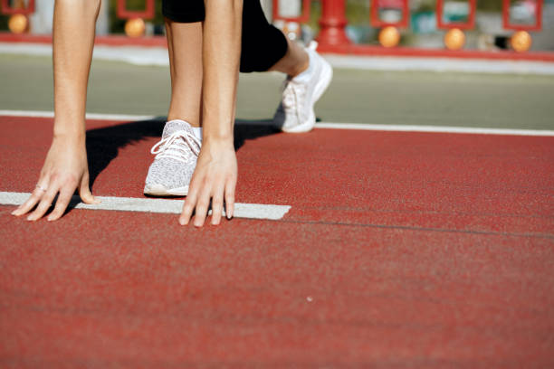 istock Woman runner at starting position ready for sprint. Empty space 1325896313