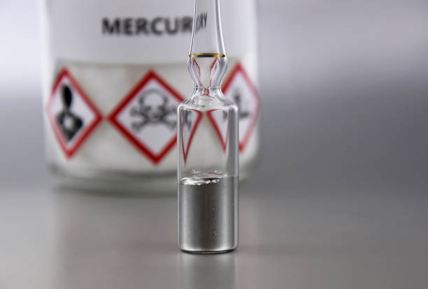 Mercury chemical element stock images Laboratory accessories images. Mercury in a sealed ampoule stock photo. Laboratory equipment on a silver background. Hg, toxic chemical element stock images periodic table photos stock pictures, royalty-free photos & images