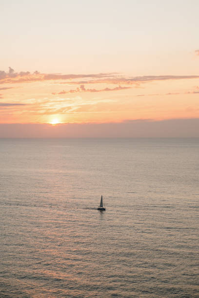 istock Sailing ship in the ocean at sunset 1325897403