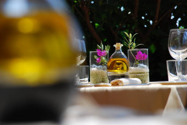istock Table with glasses and a bottle with extra virgin olive oil 1325897588