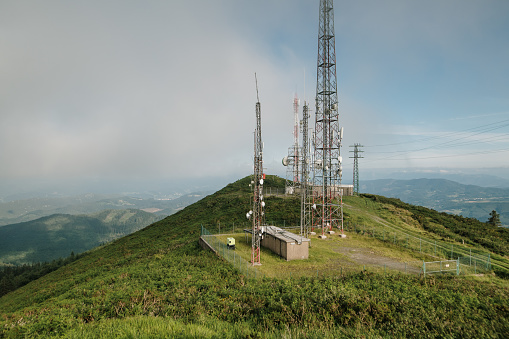 Telecommunications towers on top of a mountain with antennas