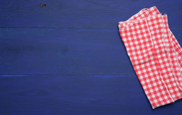 istock folded red and white cotton kitchen napkin on a wooden blue background, top view 1325901781