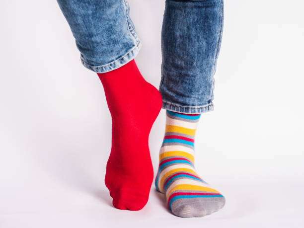 istock Men's legs and bright socks. Without shoes 1325902168