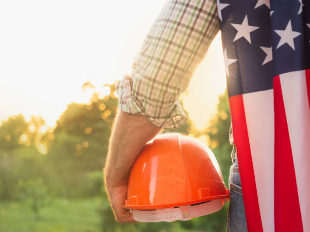 istock Handsome man holding US Flag. Labor and employment concept 1325902341