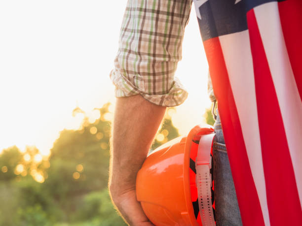 istock Handsome man holding US flag in his hands 1325902985