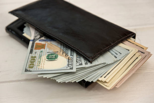 istock Dollars banknotes in a dark leather wallet 1325903204