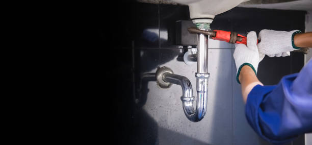 istock Plumber fixing white sink pipe with adjustable wrench. 1325904646