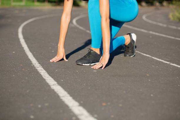istock Woman runner  in start position train before the race. Empty space 1325905810