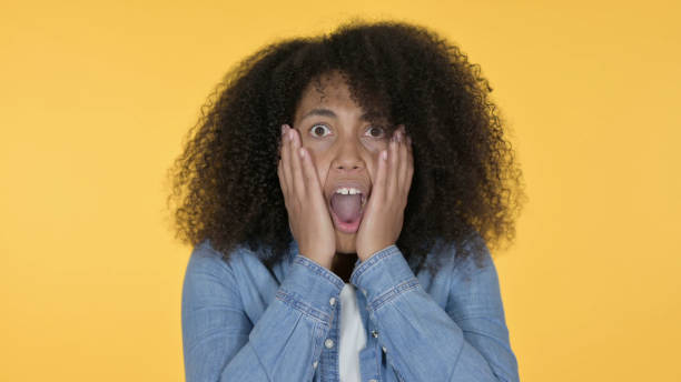 istock Young African Woman having Loss, Yellow Background 1325906685