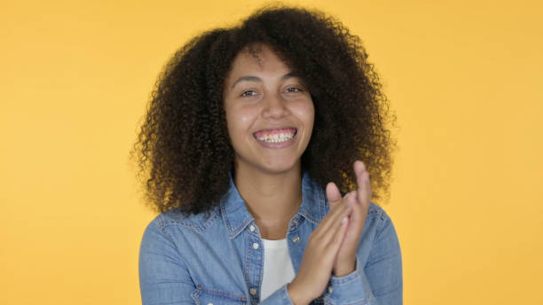 istock Positive Young African Woman Clapping, Yellow Background 1325906695