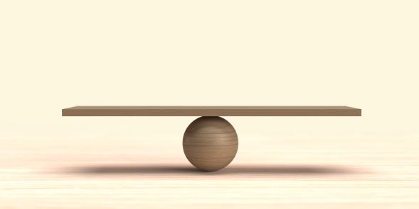 Side view on a wooden ball balancing a long brown stick on bright background with large copy space. Meditation and balance for well-being. Keep balance in investment.