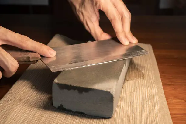 Sharpen a cleaver knife with a stone