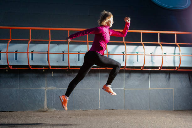 istock Senior Female Runner During Running Training in Evening City Environment. Horizontal Image Composition 1325911739