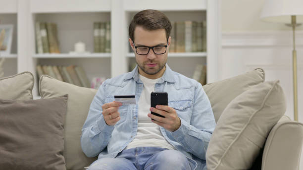 istock Successful Online Shopping on Phone by Young Man 1325912959