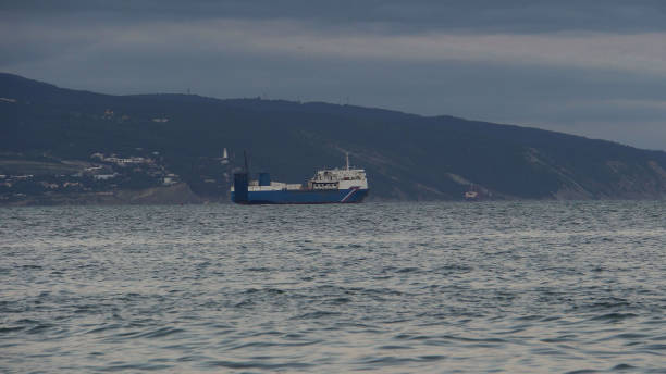 istock Blue ship sails near the lighthouse 1325913507