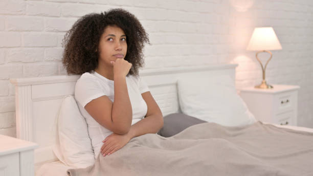 istock Pensive Young African Woman Thinking in Bed 1325915917