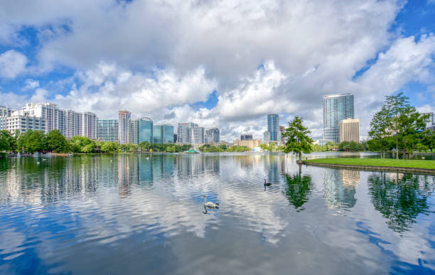 Orlando Florida Downtown Skyline During Summer Over Lake Eola Park Orlando Florida downtown skyline during the summer over Lake Eola. southeast stock pictures, royalty-free photos & images