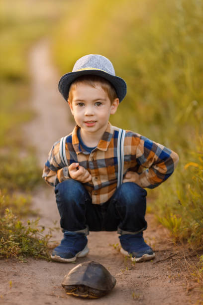 istock little boy exploring nature in the meadow 1325917602