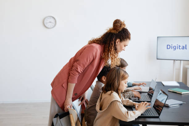 istock Young Female Teacher in IT Class 1325918635