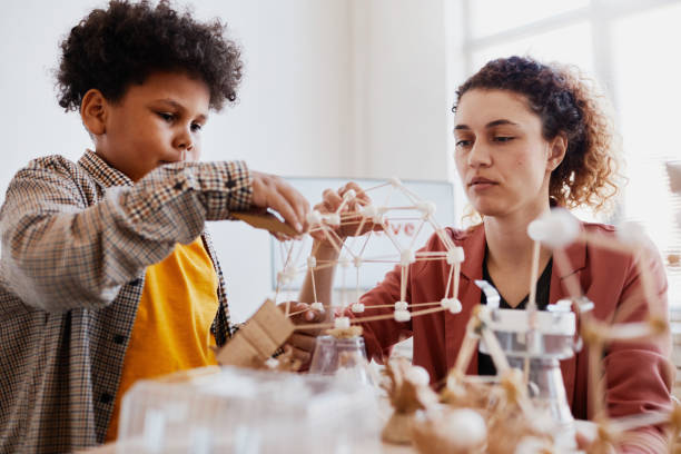 istock Africa American Boy Building Model in Class 1325918636
