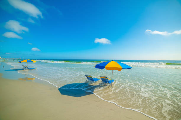 Parasols and beach chairs in Daytona Beach foreshore. Florida, USA