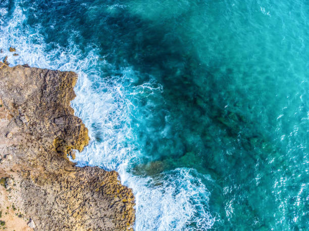 istock Rocky shore and blue sea seen from above 1325919849