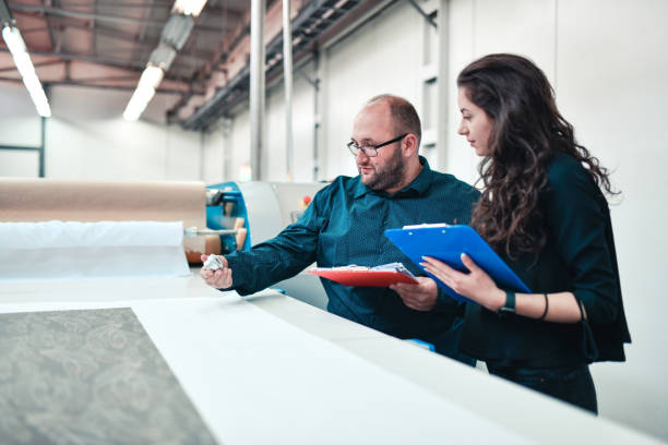istock Two Supervisors In Textile Factory Checking Printing Roller Condition And Cloth Quality 1325920161