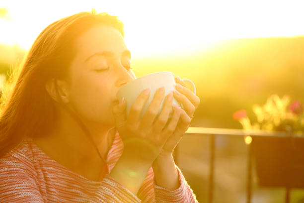 istock Woman relaxing drinking coffee at sunset 1325920219